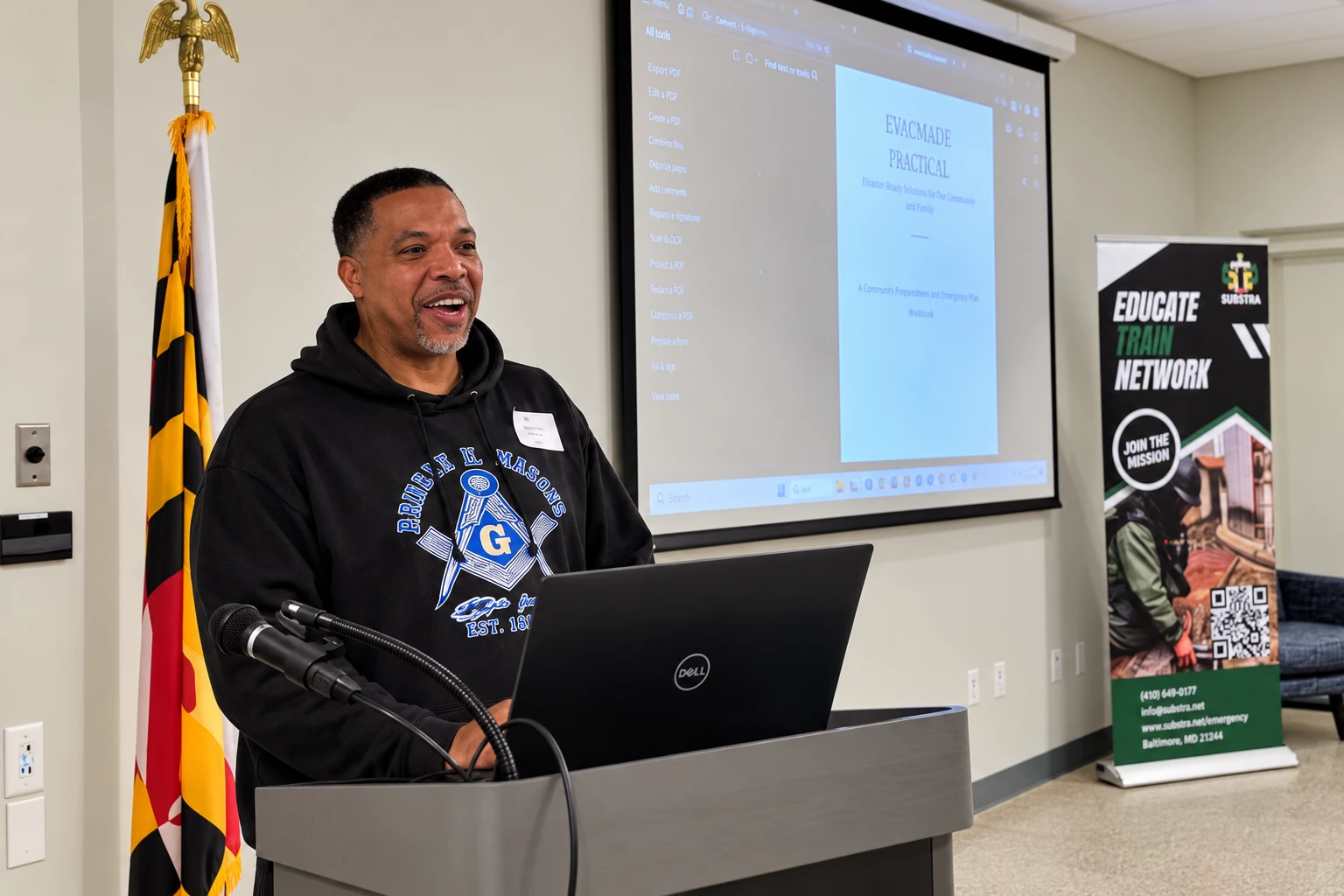 A participant speaking beside a projected project during the Charles County build afternoon