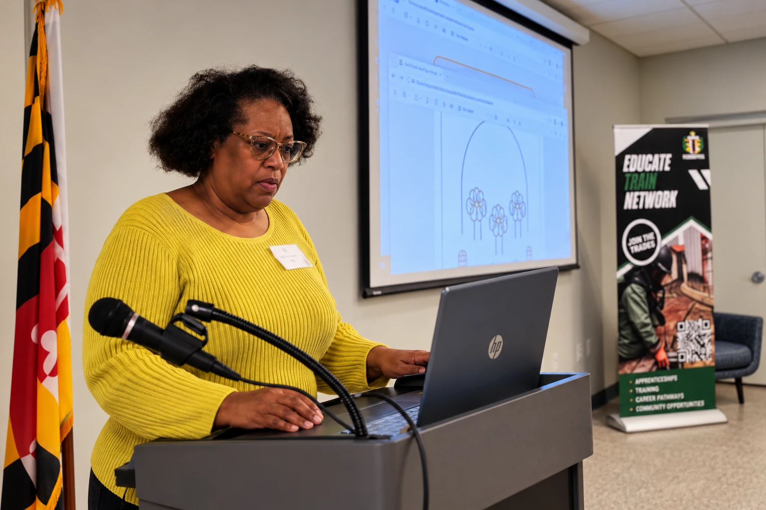 A community participant sharing a project from a laptop at the build afternoon